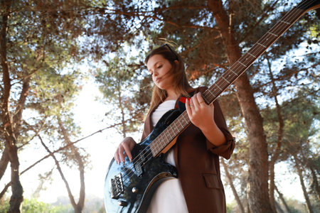 Italian Girl Plays Bass In The Mountains Among The Trees