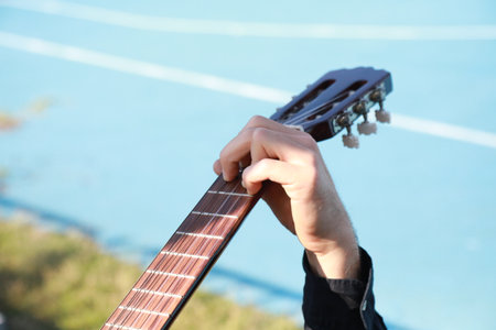 Man Plays Music With Classical Guitar Inexpensive Instrument