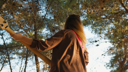 Girl Plays Bass Music Instrument In The Mountains Among The Trees