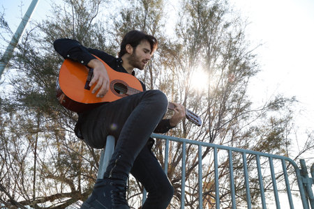 Player Delights In Chords With The Guitar And Stands Before Concert
