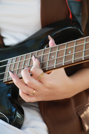 Hands Girl Plays The Bass Musical Instrument Among The Trees In The Parkの写真素材