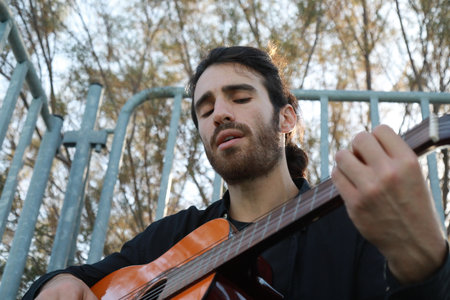 Man Plays Music With Classical Guitar Inexpensive Instrument