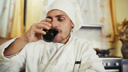 Man Chef Happy Drinking His Homemade Italian Calabrian Red Wine In The Kitchenの写真素材
