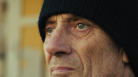 Old Worried Man Looks Around Close Upの写真素材