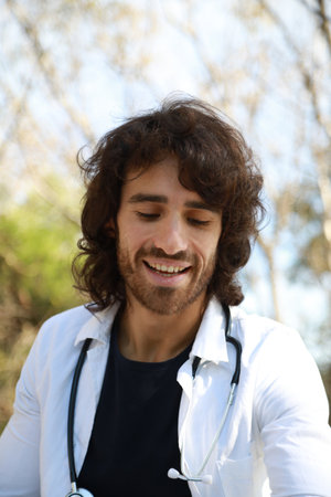 Young Man Trainee Doctor Repeat Lesson Sitting in Park Outside University Clinic