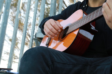 Man Plays Music With Classical Guitar Inexpensive Instrument