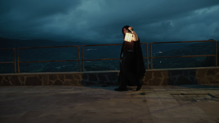 Enigmatic Woman Walks With A Lantern In Her Hand At Night In The Mountainsの写真素材