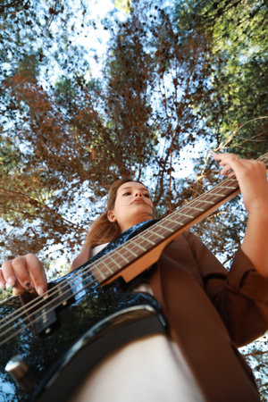 Italian Girl Plays Bass In The Mountains Among The Trees