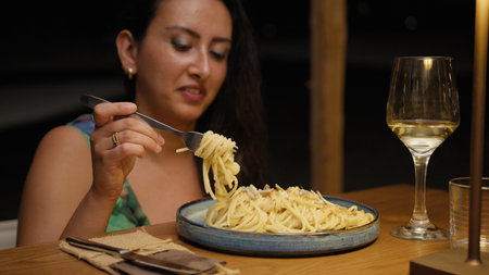 Smile On The Face Of A Woman Eating Spaghetti For Dinner At The Restaurantの写真素材