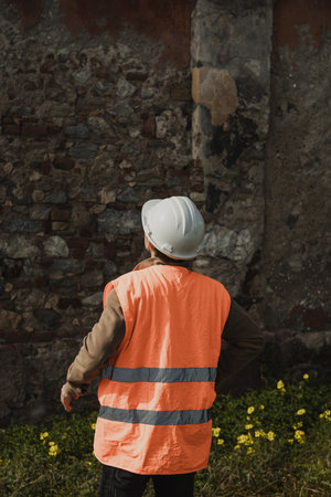 Construction Worker Measuring And Testing An Old Wall Buildingの写真素材