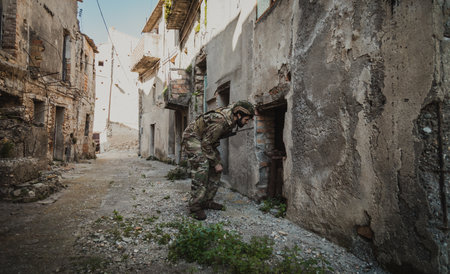 Soldier Looks Through The Destroyed Door Of An Old Houseの写真素材