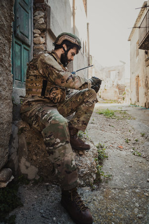 Young Soldier In War Opens The Compass To Understand The Locationの写真素材