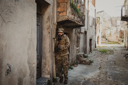 Soldier Communicates With Walkie Talkie Before Raiding A Houseの写真素材