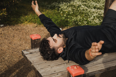 Man Struggles to Do Sit Ups During Outdoor Workoutの写真素材