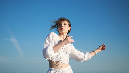Italian Girl Dances On The Soft Beach Near Ocean In White Clothes