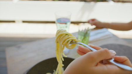 Spaghetti On A Fork Hanging In The Air Ready To Be Eaten For Lunchの写真素材