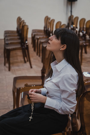 Woman Immersed In The Prayer At The Church With A Rosary