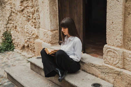 Woman Reading The Bible And Flipping Pages At The Entrance Of The Church