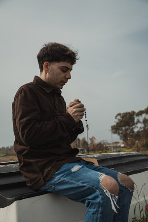 Man praying with a rosary
