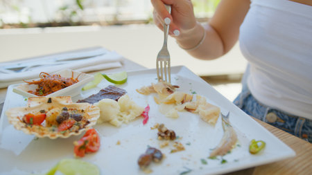 Woman Starting Lunch With Beautiful Appetizer Dish At The Beach Resortの写真素材