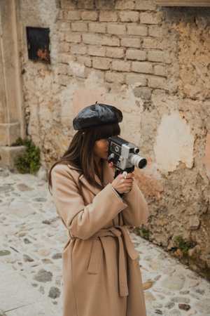 Woman With A Vintage Camera Looking Around The Old Town Streets For Inspiration