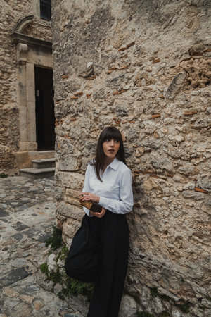 Young Women in White Shirt Reading Book In Vintage Hamletの写真素材