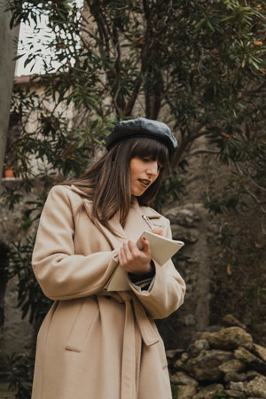 Woman Taking Notes Amazed By The Nature In The Small Italian Townの写真素材