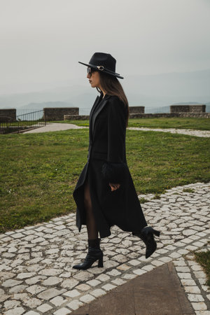 Woman Walking On The Stone Path Inside The Squareの写真素材