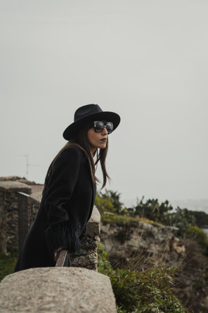 Woman Is Watching The Landscape Behind The Railingの写真素材