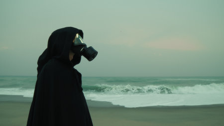 A Man Stands on a Deserted Beach Near Ocean