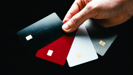Colorful payment cards held in hand by a person during Black Friday shopping