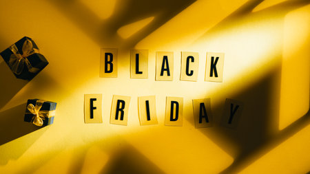 Black Friday Text On Yellow Background With Light Beamの写真素材