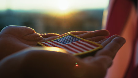 Hands Of An American Soldier Holding An American Flag Patch For Memorial Dayの写真素材