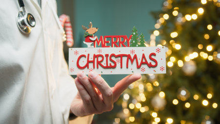 Merry Christmas Text From an Anonymous Doctor in Hospital in Front of the Treeの写真素材