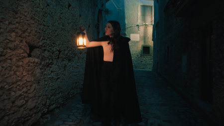 Woman With Mysterious Lantern On The Streets Of The Night Cityの写真素材