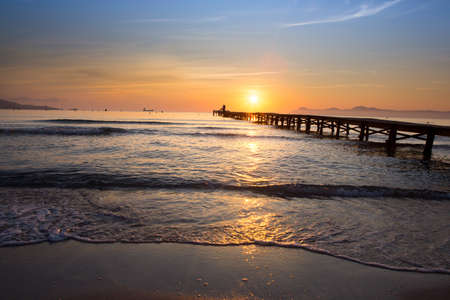 Sunset on the beach Sea in Spain - Majorca. view of Jetty / Pier の写真素材