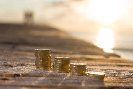 Picture of four piles  British pound coins. UK Money, New Pounds in a Warm Light. の写真素材