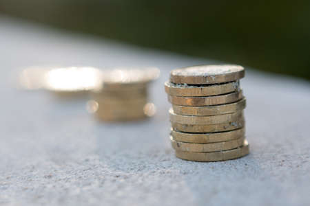Picture of four piles  British pound coins. UK Money, New Pounds in a Warm Light. の写真素材
