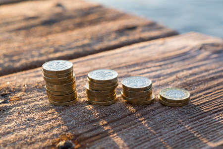 Picture of four piles  British pound coins. UK Money, New Pounds in a Warm Light. 