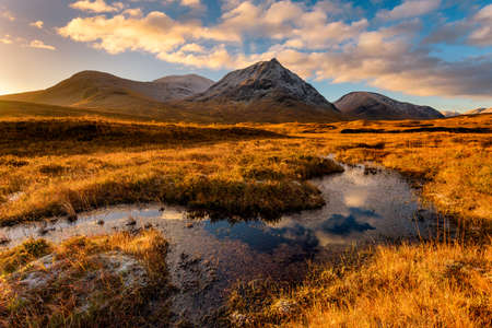 Golden Morning Light At Rannoch Moor With Snowcapped Scottish Mountains.の写真素材
