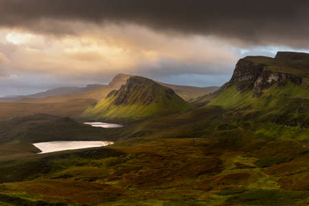 Moody rain clouds over popular travel destination; The Quiraing on the Isle of Skye, Scotland, UK. Scenic Scottish landscapes in the wilderness.の写真素材