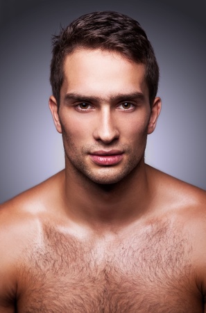 portrait of handsome guy on gray の写真素材