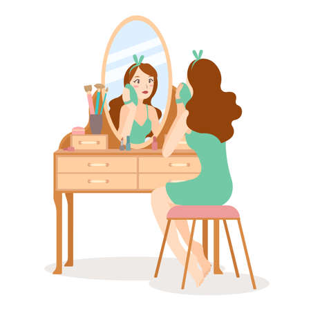 Girl make up and clean her face in front of mirror at dressing table. Skincare and cosmetic daily routine. Isolated vector in flat style.のイラスト素材