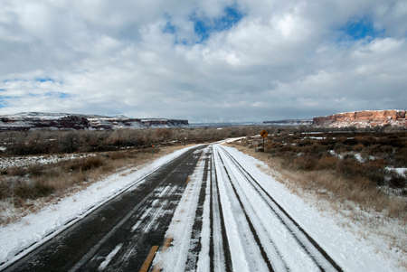 Winding snow covered road en route to Monument Valley, Utah, USAの写真素材