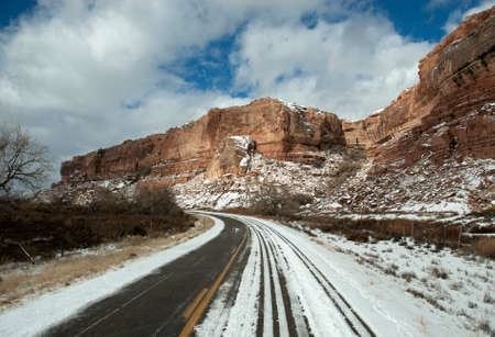 Winding snow covered road en route to Monument Valley, Utah, USA