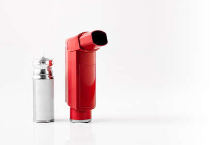 Red MDI Inhaler. Asthma and Allergy aerosol for people with respiratory problems. White neutral background.の写真素材