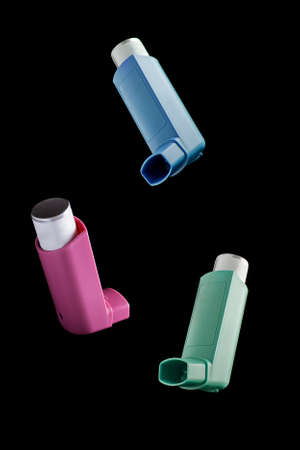 Bunch of MDI Inhaler over black background. Asthma and Allergy aerosol for people with respiratory problemsの写真素材