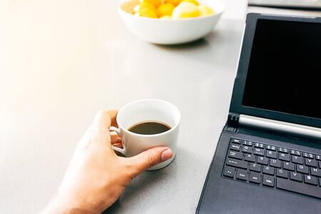 Man having a cup of coffee before he starts to work at home