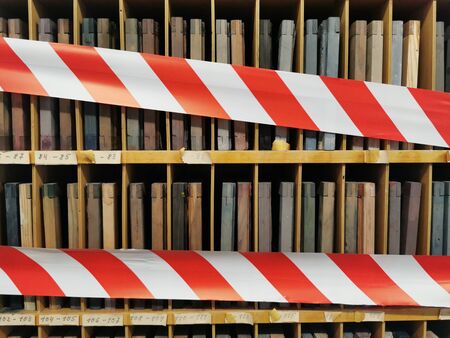 Wooden shelf locked with red and white barrier tape in a old factoryの写真素材