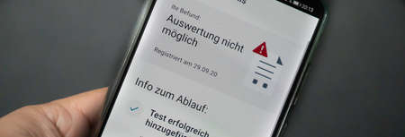 Corona warning app on a smartphone displays the test result - Incorrect - German words on the pictureの写真素材